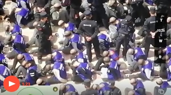 China footage reveals hundreds of blindfolded and shackled prisoners